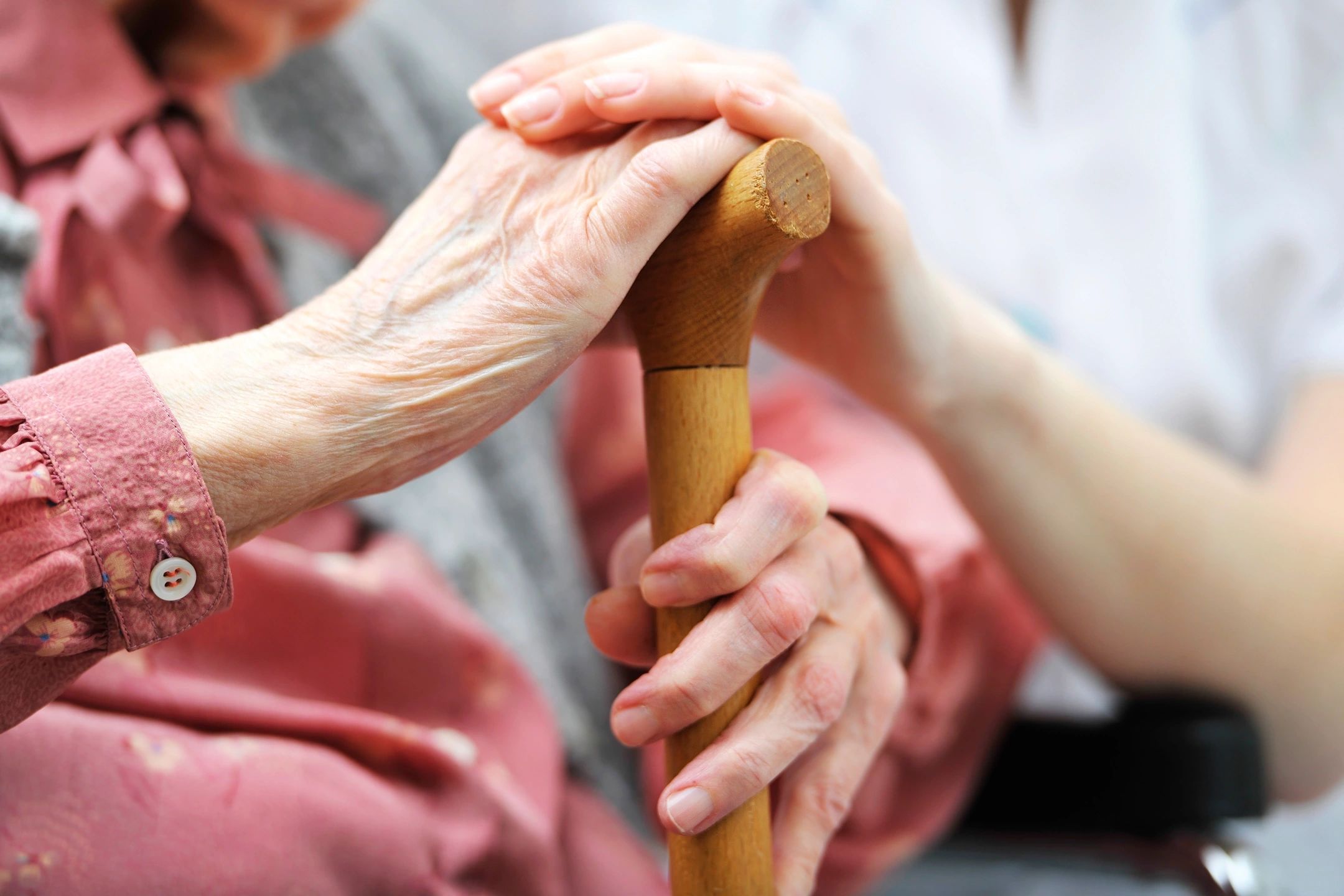 Older woman hand on cane